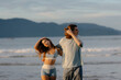 © Mirrorstudio - Young adults enjoying a serene beach at sunset