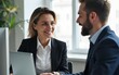 © lei - Two busy professional business people working in office with computer. Middle aged female executive manager talking to male colleague having conversation showing software online solution on laptop.