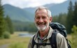© liang - Happy older man standing in nature park enjoying natural park landscape. Smiling mature active traveler exploring camping tourism nature lake and mountains travel journey feeling freedom.