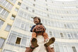 © Westend61 - Father and son walking outdoors laughing in city near high rise building