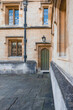 old green door and lamp in one of Oxford University college's alleyways