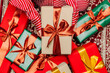 © Westend61 - Christmas gifts with ribbons on carpet indoors during holiday celebration