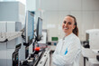 © Westend61 - Smiling laboratory professional working with data in a modern clean room