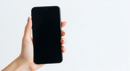Female hand holding a black smartphone with a blank screen against a white background.