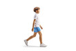 © Ljupco Smokovski - Full length profile shot of a boy in white t-shirt and blue shorts walking
