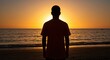 © hola - Silhouette Man Watching Golden Sunset on Ocean Beach