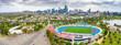 © Austockphoto - Aerial panorama of a sports arena and carpark in parkland in front of a city skyline at Albert Park