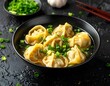 © Nonon - Traditional Asian dumpling soup with wontons in a black bowl, garnished with fresh chopped green onions and served with chopsticks.