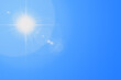 © Reza - Sun in blue sky. Bright warm sun and lens flare in clear summer sky, sunlight with sunshine glare rays. Vector nature sunny spring landscape, bright sparkle burst