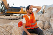 © Maria Vitkovska - Tired construction worker wiping sweat from forehead in quarry
