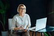 © okrasiuk - Professional Psychotherapy. Successful female Psychologist Smiling To Camera Sitting On armchair In Office. Mature 50s middle-age professional portrait of teacher, coach, mentor, therapist, counselor