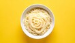 © Edge - White bowl of plain spaghetti on bright yellow background
