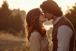 © stanhert - A man and a woman kissing in a field at sunset