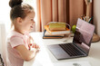 © Maria - Curious little girl using laptop at desk