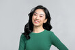© Marc Tran/Stocksy - An attractive asian woman feeling happy in front of a white background