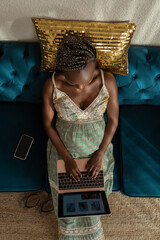 Pregnant woman browsing online store using laptop