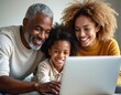 © miss irine - African American parents help daughter with scholarship applications online, fostering dreams for future success. Family smiles looking at laptop, planning education, financial aid together.
