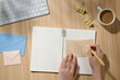 © Marc Tran/Stocksy - Person Writing on Notebook by Coffee in Bright Workspace Setting