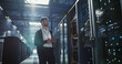 © Aleksei Gorodenkov/Stocksy - Technician works in data center.