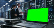 © Aleksei Gorodenkov/Stocksy - Laptop with green screen chroma key on the deks in data center.