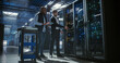 © Aleksei Gorodenkov/Stocksy - Two technicians work in data center.