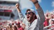 © Tanu - Excited fan celebrates a winning moment during a college football game at a stadium in the afternoon