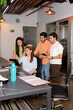 © Moy Ortega/Stocksy - A group of office workers having an informal meeting at a shared desk