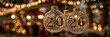 © LARTs Studio - New Year's Eve 2026 Decorations: A captivating close-up view, illuminated by soft bokeh lights, features three exquisite glass ornaments delicately displaying the year 2026.