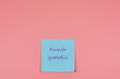 © JF:Carpio - Sticky note with thank you word in foreground with copy space on pink background