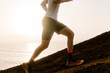 © Adrian Rodd/Stocksy - Anonymous high performance athlete speeding up a rocky slope