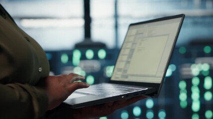 Close up of software developer working in data center to optimize network infrastructure. Programmer in server farm diagnosing and resolving equipment malfunctions using device