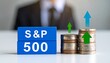 © photostockatinat - The S&P 500 index represented by coins and blue blocks, business growth concept
