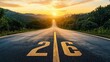 © Luminary Shots - A long straight road with the number 26 painted on it leads to a beautiful sunset over the horizon