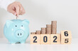 © Jo Panuwat D - 2025 end year to Happy New Year 2026 with piggy bank. Resolution, Goals, Plan, Action, Money Saving, Retirement fund, Pension, Investment and Financial concepts