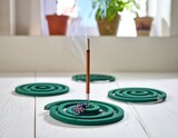 Scented coil incense on white wood