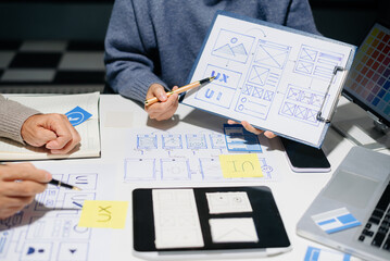 Wall Mural - UX UI design with wireframes, prototypes, and color planning. Creative web design development with real people in a modern tech office.