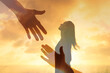© kieferpix - Outstretched hands reaching toward the silhouette of a woman, giving hope, support, and compassion