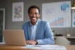 © Eve - Confident African American businessman smiling at desk with laptop in modern office. Concept of leadership, success, entrepreneurship, career growth, innovation, professional goals.