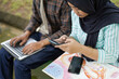 © Fajar - Students Collaborate on Project Using Laptop and Smartphones Outdoors