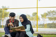 © Fajar - Young Couple Studying Together Outdoors A Shared Learning Experience