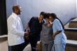 © wavebreak3 - Healthcare professionals in scrubs laughing together during break at hospital