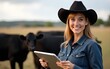 © Ryan - Portrait of black cow breeder with tablet standing at cow's ranch and smiling at camera. High quality