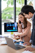 © Wasana - Business people analyzing charts on laptop and digital tablet in office