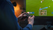 © Gorodenkoff - Man Playing an Online Football Match From the Comfort of His Living Room Couch. Male Using a Console Controller, Winning a Video Game Soccer Tournament with a Successful Goal