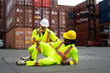 © Suney - Blue collar worker is take care injury co worker at container warehouse.