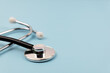 © cn0ra - Close up of stethoscope on blue background medical concept