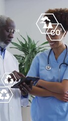 Wall Mural - animation of eco icons and data processing over diverse doctors