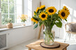© PicsCreator - Bright sunflowers arranged in clear glass vase, natural daylight shining, minimalist home decor style with cheerful vibrant mood indoors