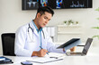 © Fahng - professional doctor wearing uniform taking notes in journal, physician therapist practitioner filling medical documents, clipboard, patient form, illness history, prescription.