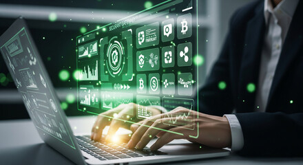Businessman using laptop with futuristic holographic interface displaying cryptocurrency and financial data charts, symbolizing digital finance and technology advancement